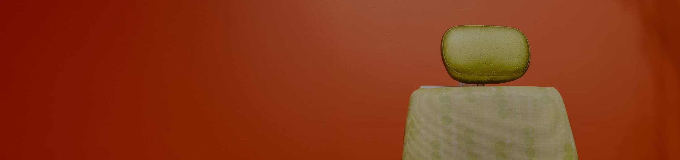 Patient chair against a red background