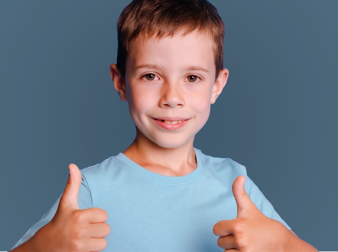 A kid giving two thumbs up