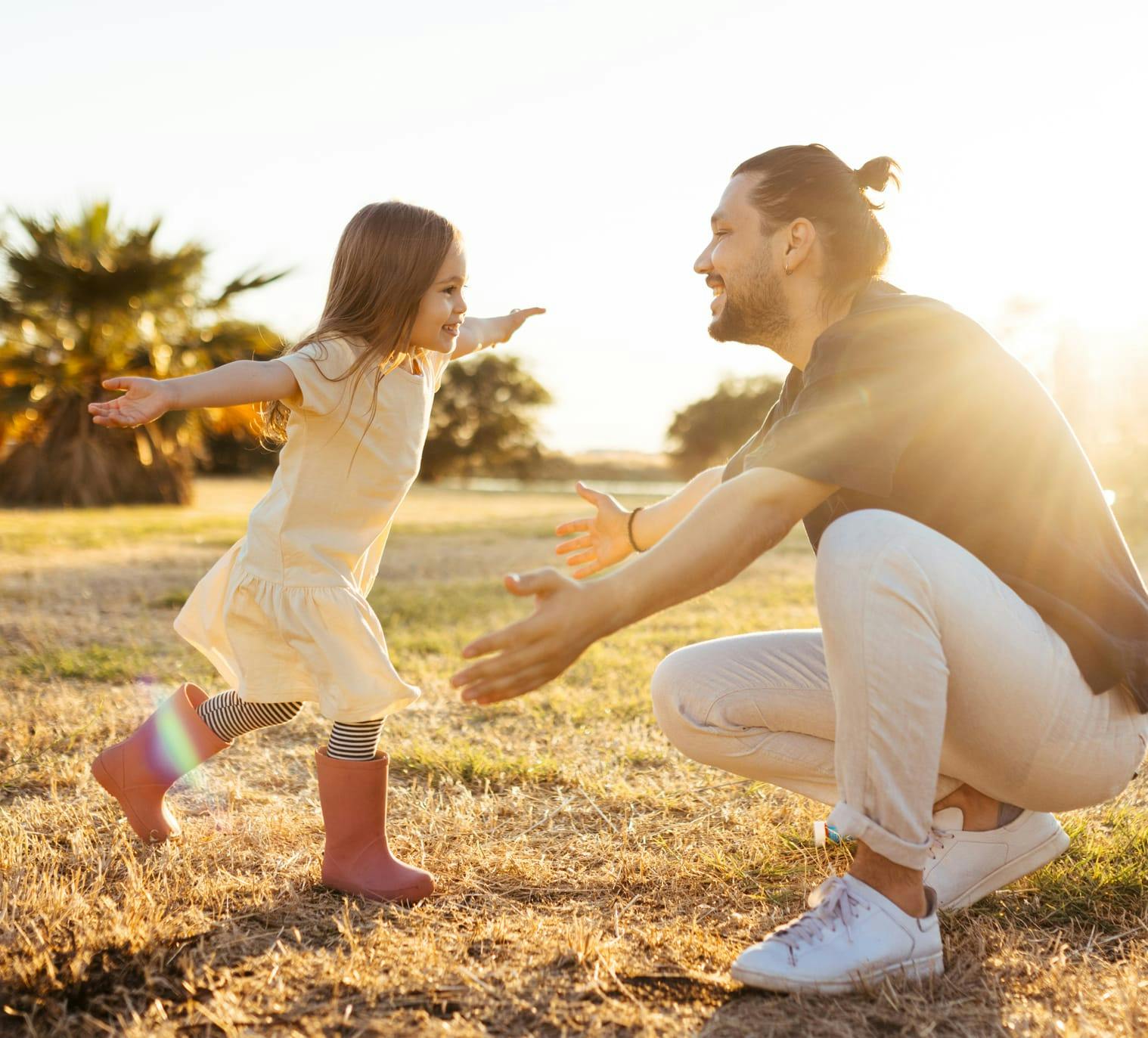 little girl running towards a man for a hug