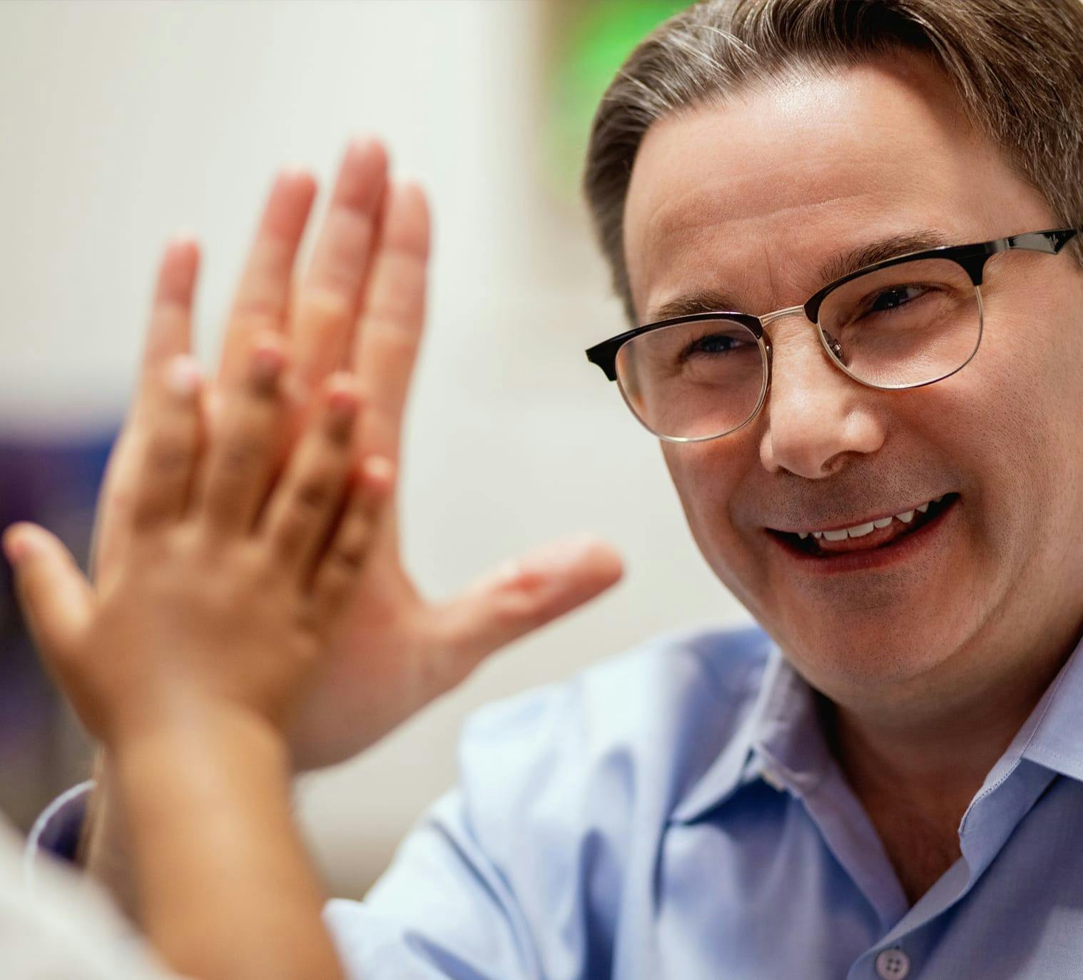Doctor high fiving a child patient