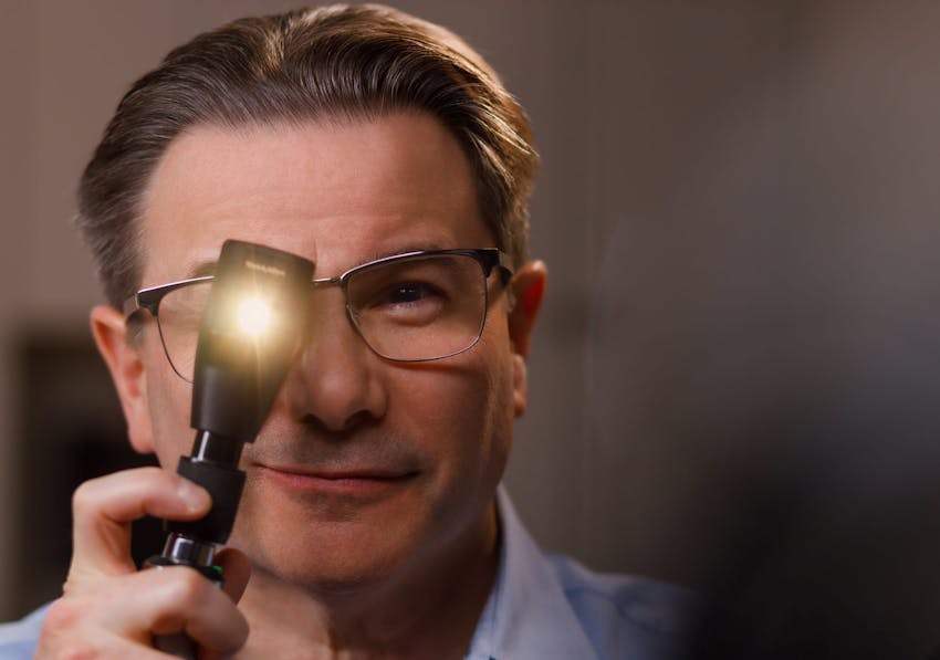 doctor looking through a flashlight