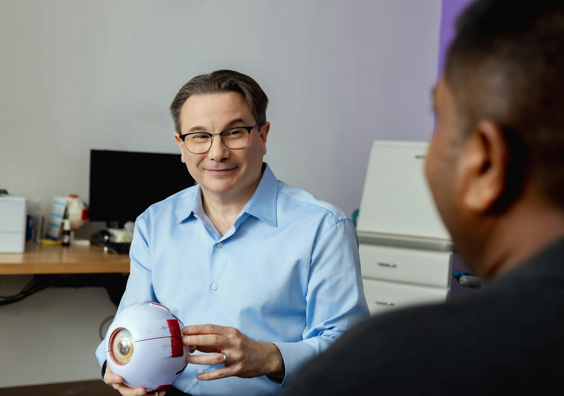 doctor holding an large fake eye