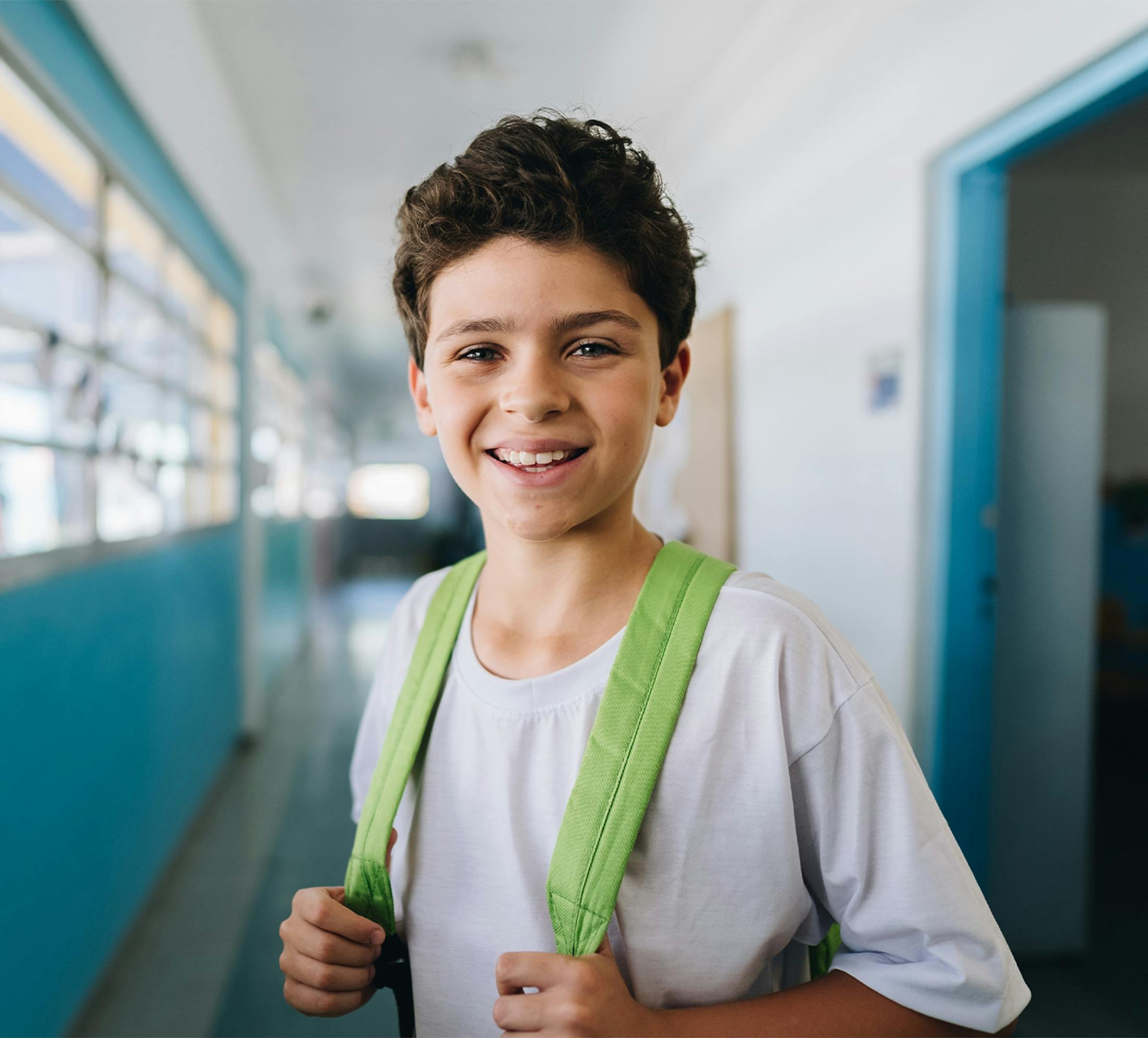 young boy in a school hallway