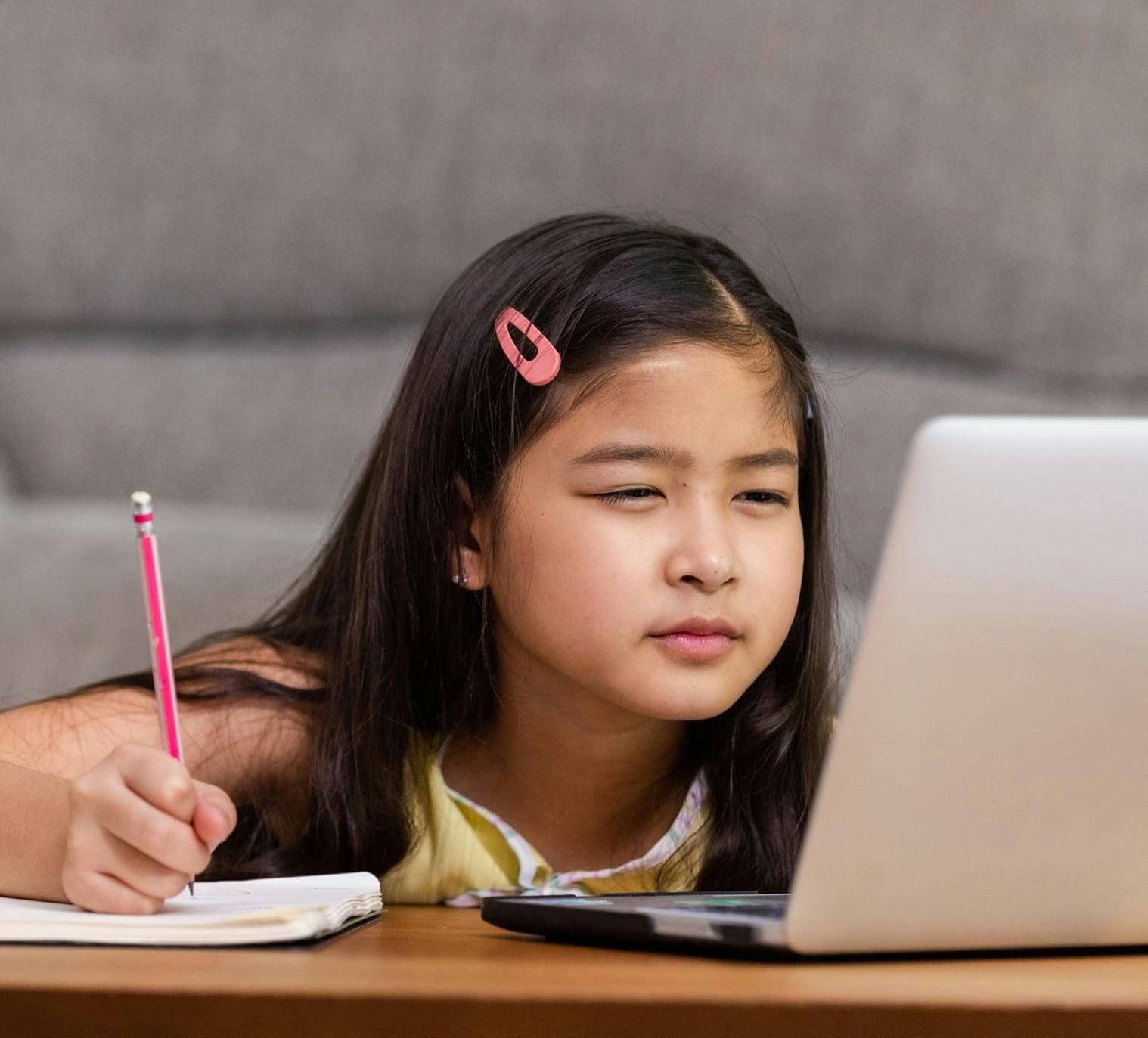young girl looking at a laptop