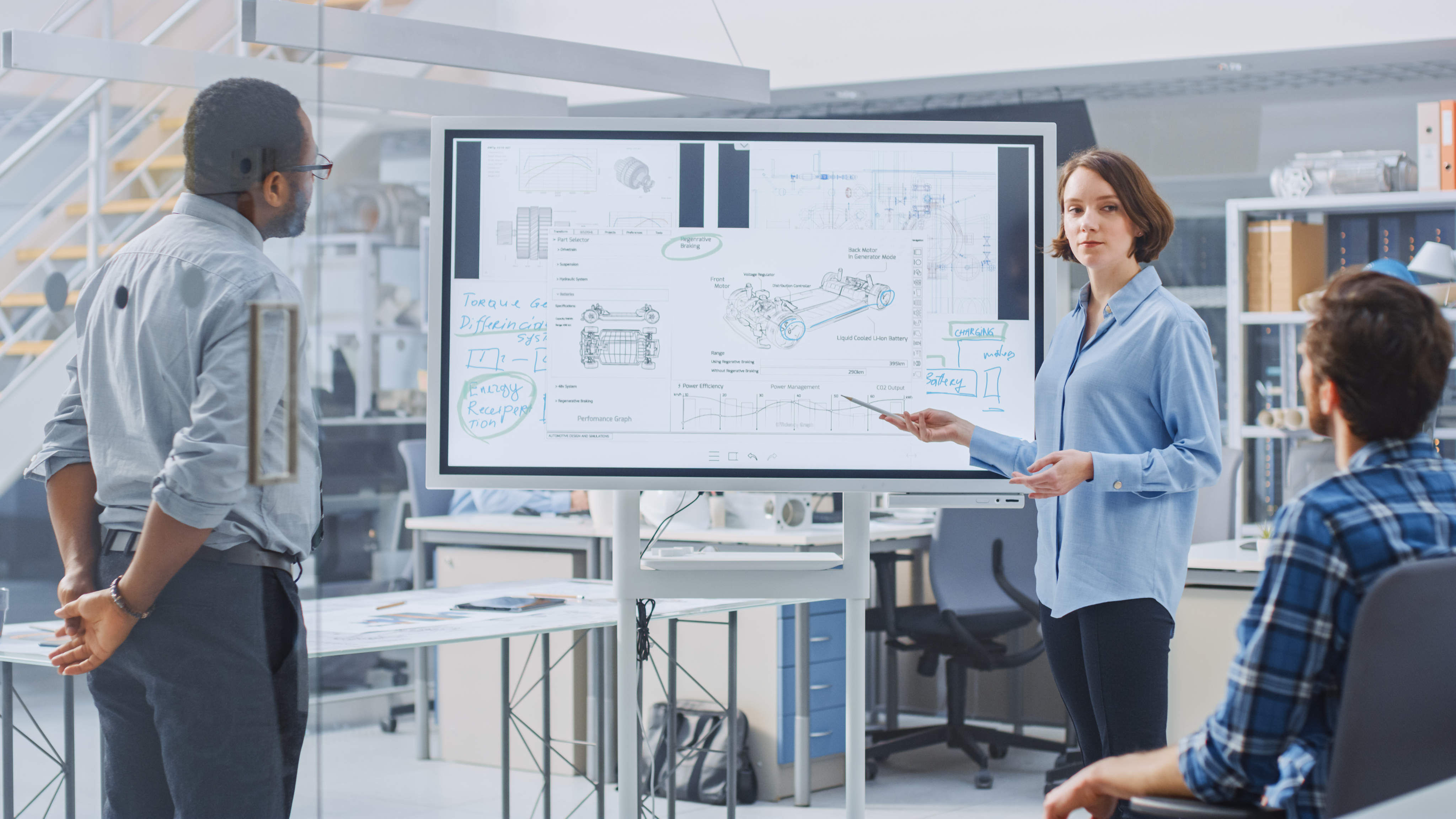 A woman presented at a digital whiteboard.