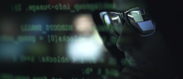 man wearing glasses with data and code overlay