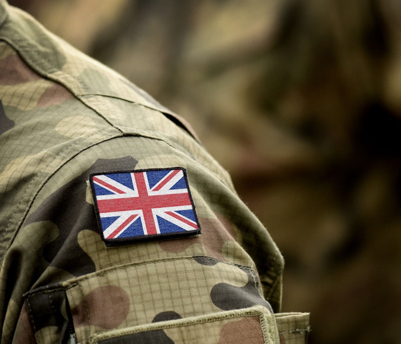 Close-up of a soldier’s camouflage uniform with a Union Jack patch on the shoulder.