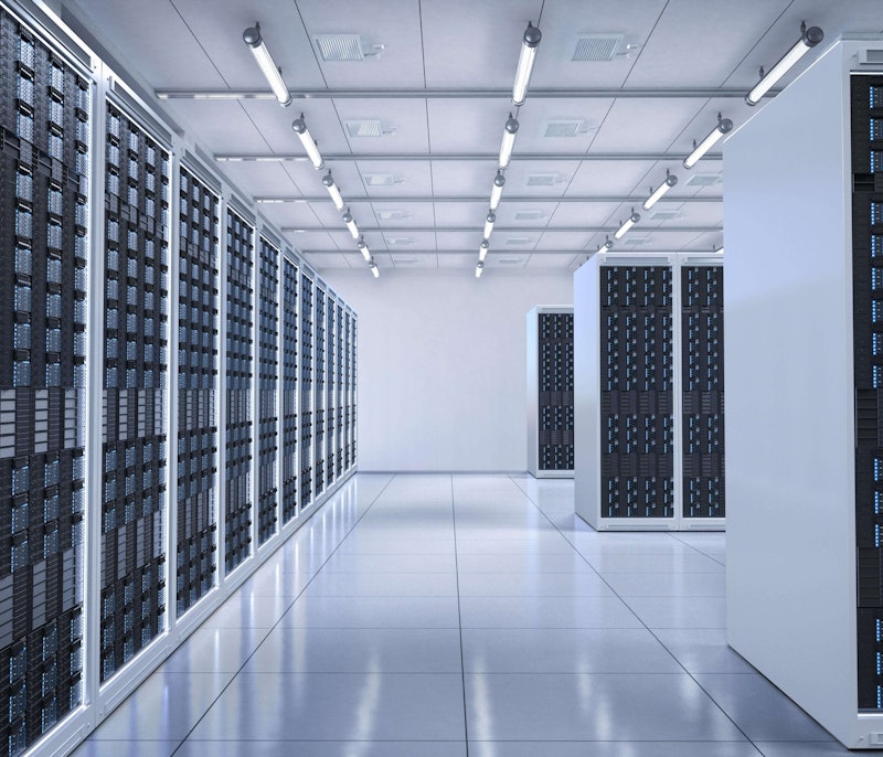 Bright, modern data centre filled with rows of server racks.