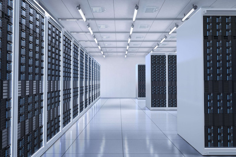 Bright, modern data centre filled with rows of server racks.