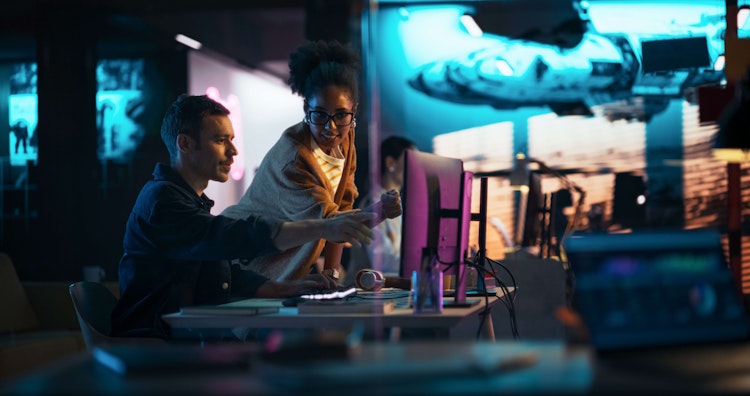 Creative professionals collaborating on a project in a modern studio.