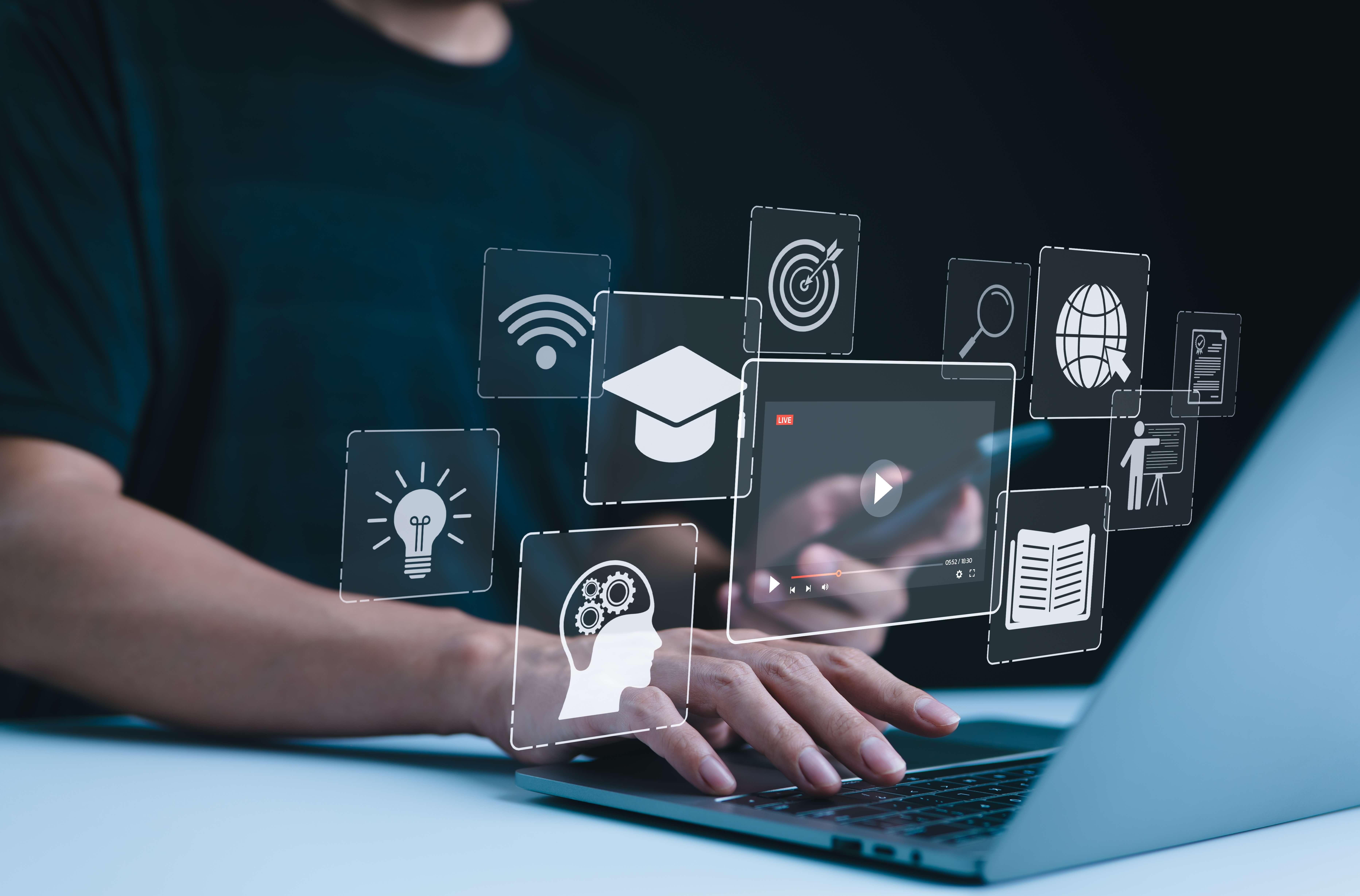 Person using a laptop with floating digital icons representing online learning and innovation.