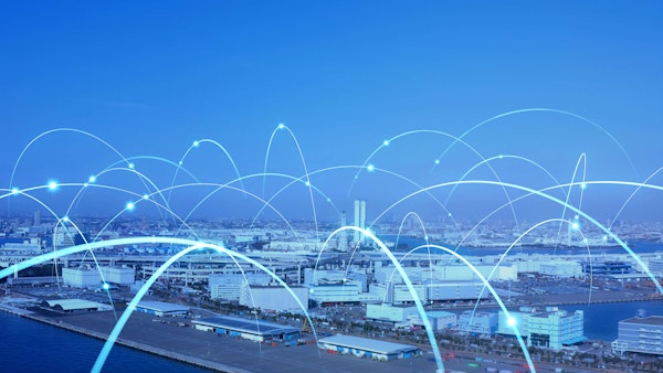 Smart city skyline with glowing network lines representing digital connectivity.