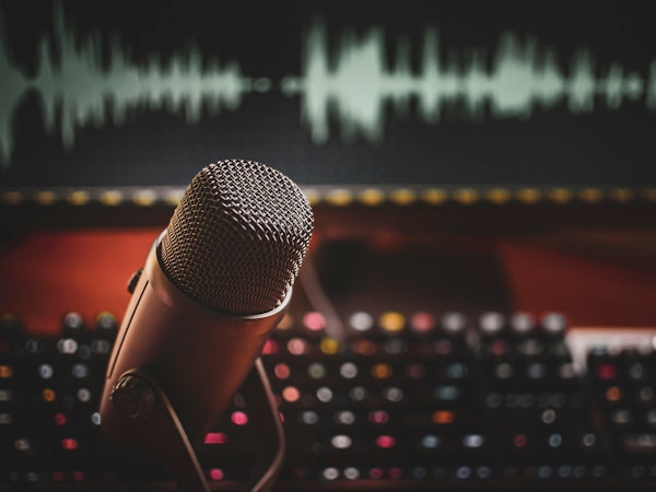 Home studio: microphone and wave form on screen fpr podcasts