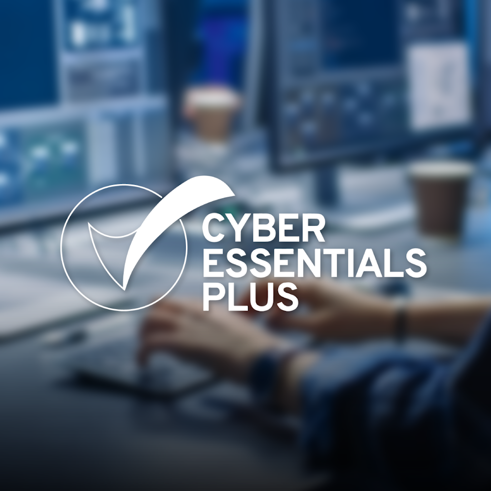 blue blurry background of cyber software on computers. Cyber essentials plus logo in white.