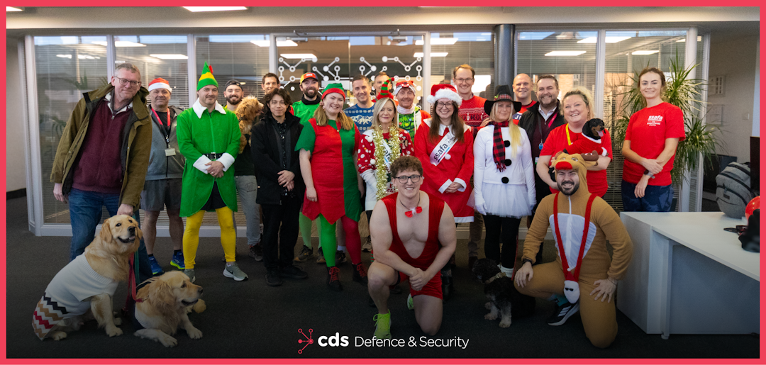 CDS DS Christmas Photo 2025 CDS DS employees in christmas fancy dress stood in a group, smiling towards camera