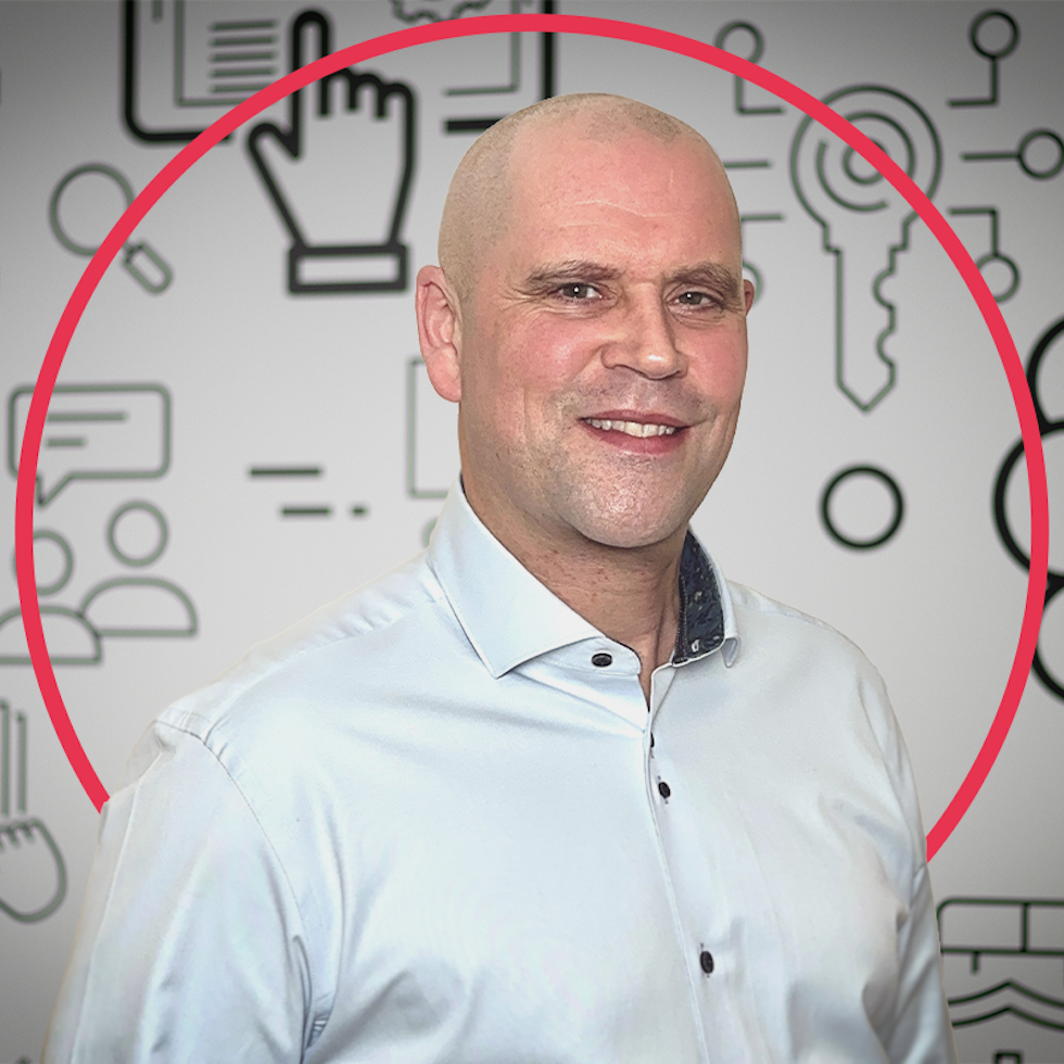 Photo of CDS DS Operations Director Jim Hamilton smiling standing infront of black & white iconography backdrop.