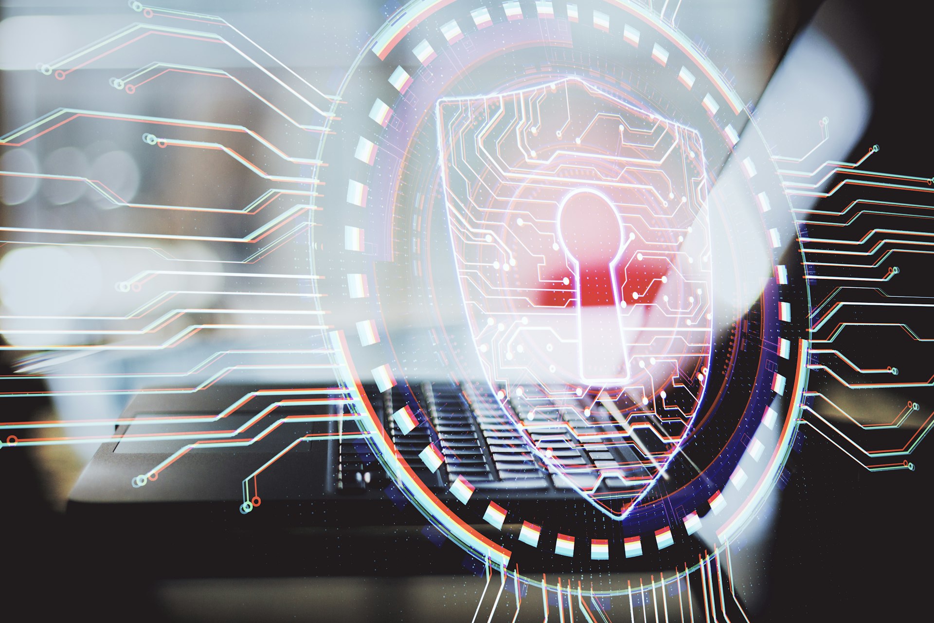 Abstract image shows a close up of a laptop and keyboard overlaid with a circular graphic depicting digital network connections and a padlock. The overall visual tone is sophisticated, with colors including red, white, and blue. This image could be used for projects related to computer security, data protection, technology, or network safety.