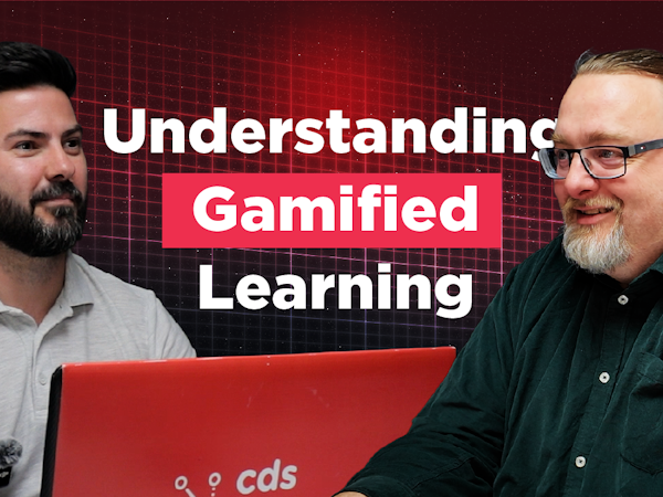 The Briefing Room Episode 9 Thumbnail image for a podcast or video episode titled “Understanding Gamified Learning.” Karl Rees sits on the left in a light grey polo shirt, facing Austen Shand on the right, who is wearing glasses and a dark green shirt. They are seated at a table with a red CDS-branded laptop between them. The background features a dark red digital grid design with large white and pink text displaying the episode title.