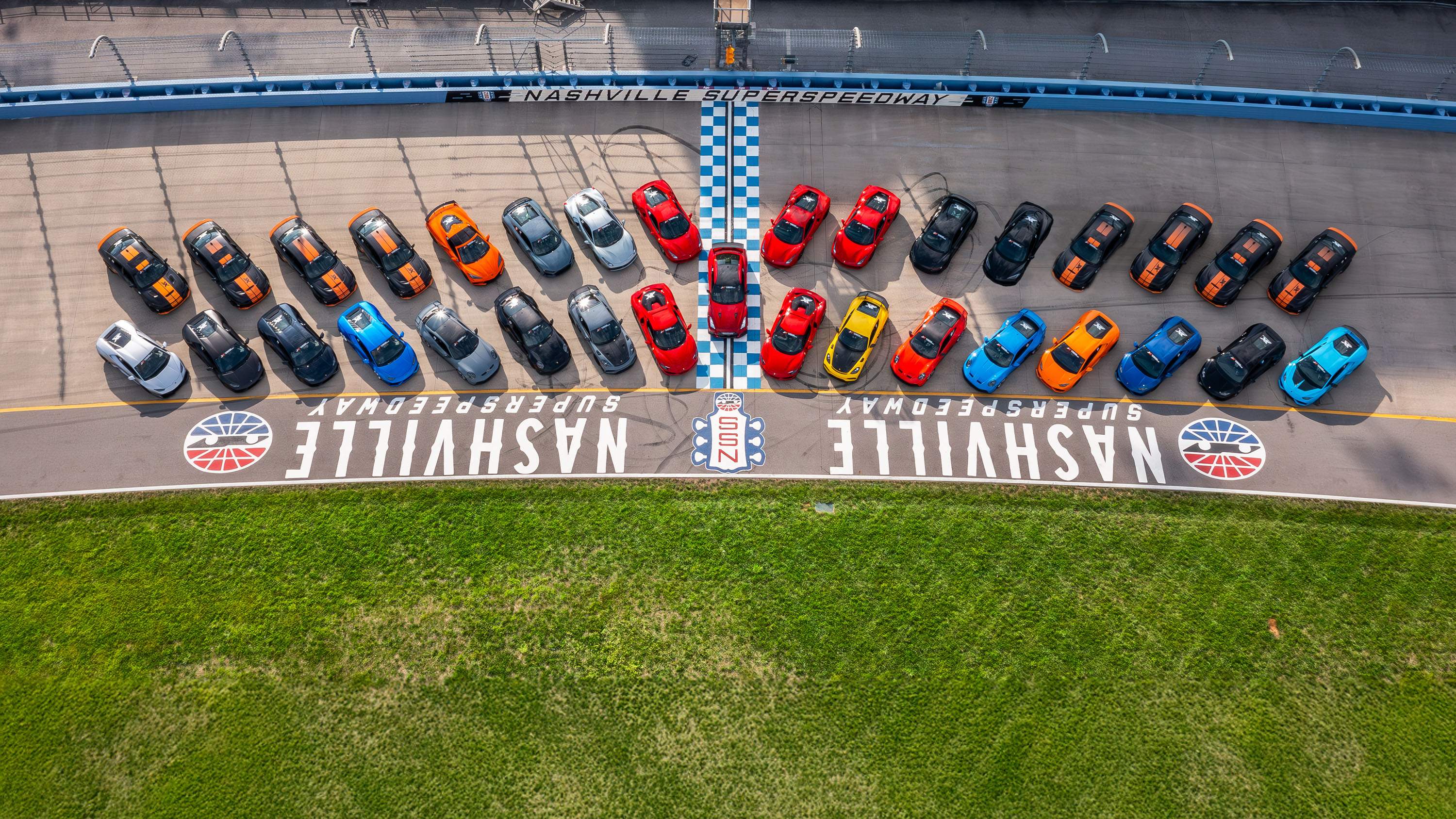 All of xtreme xperiences supercars, lined up and parked on the banked turn at Nashville Superspeedway