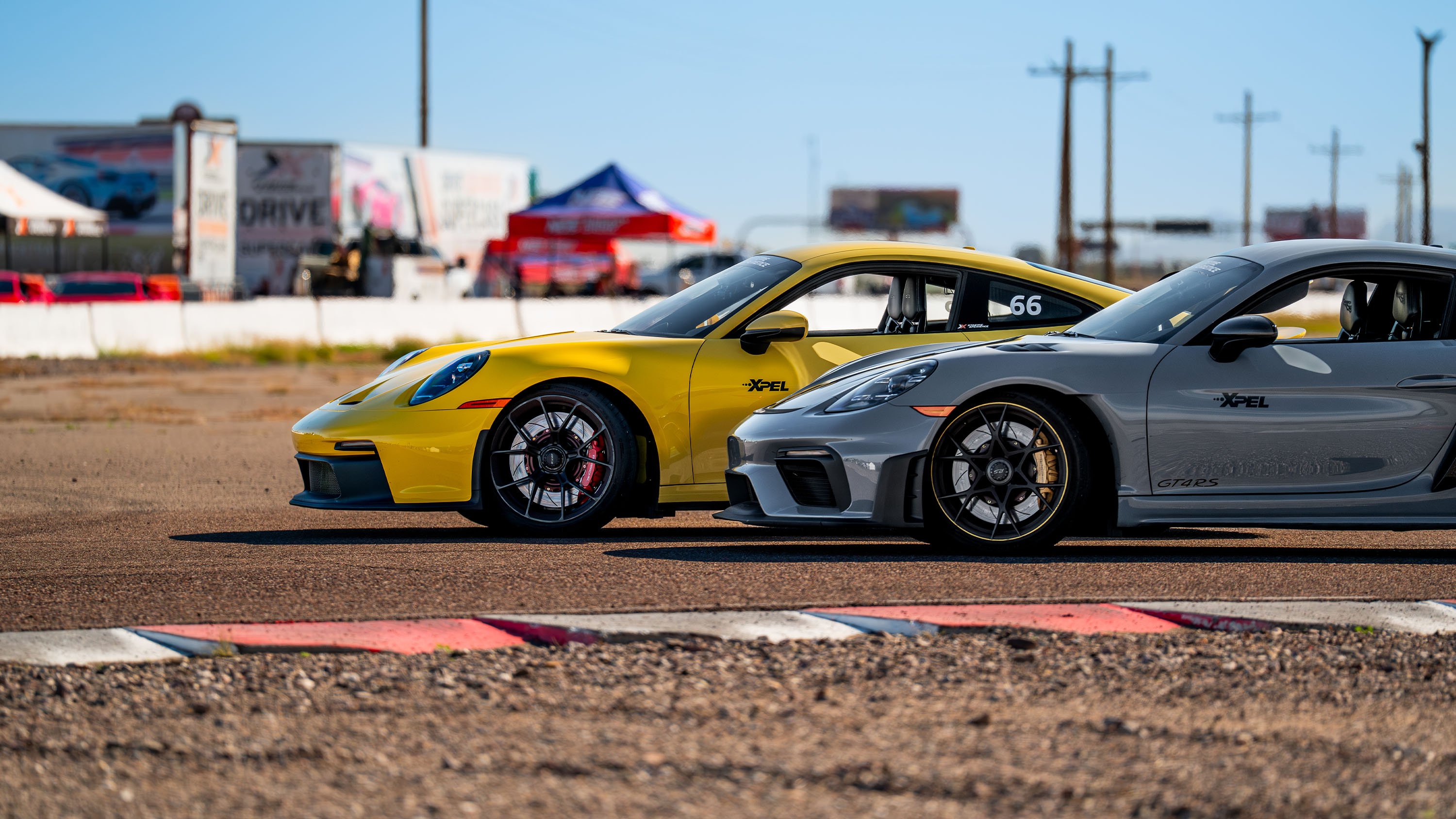 a porsche 911 gt3 and gt4 rs parked on a turn at firebird motorsports park in arizona