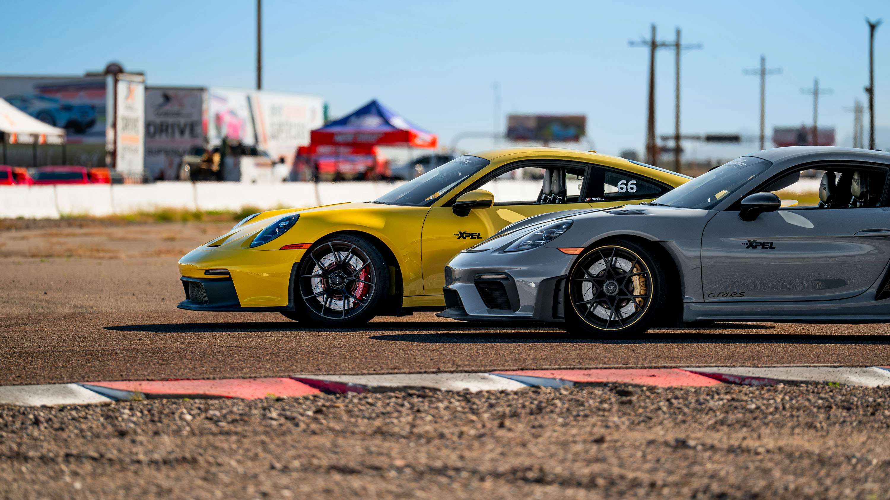 a porsche 911 gt3 and gt4 rs parked on a turn at firebird motorsports park in arizona