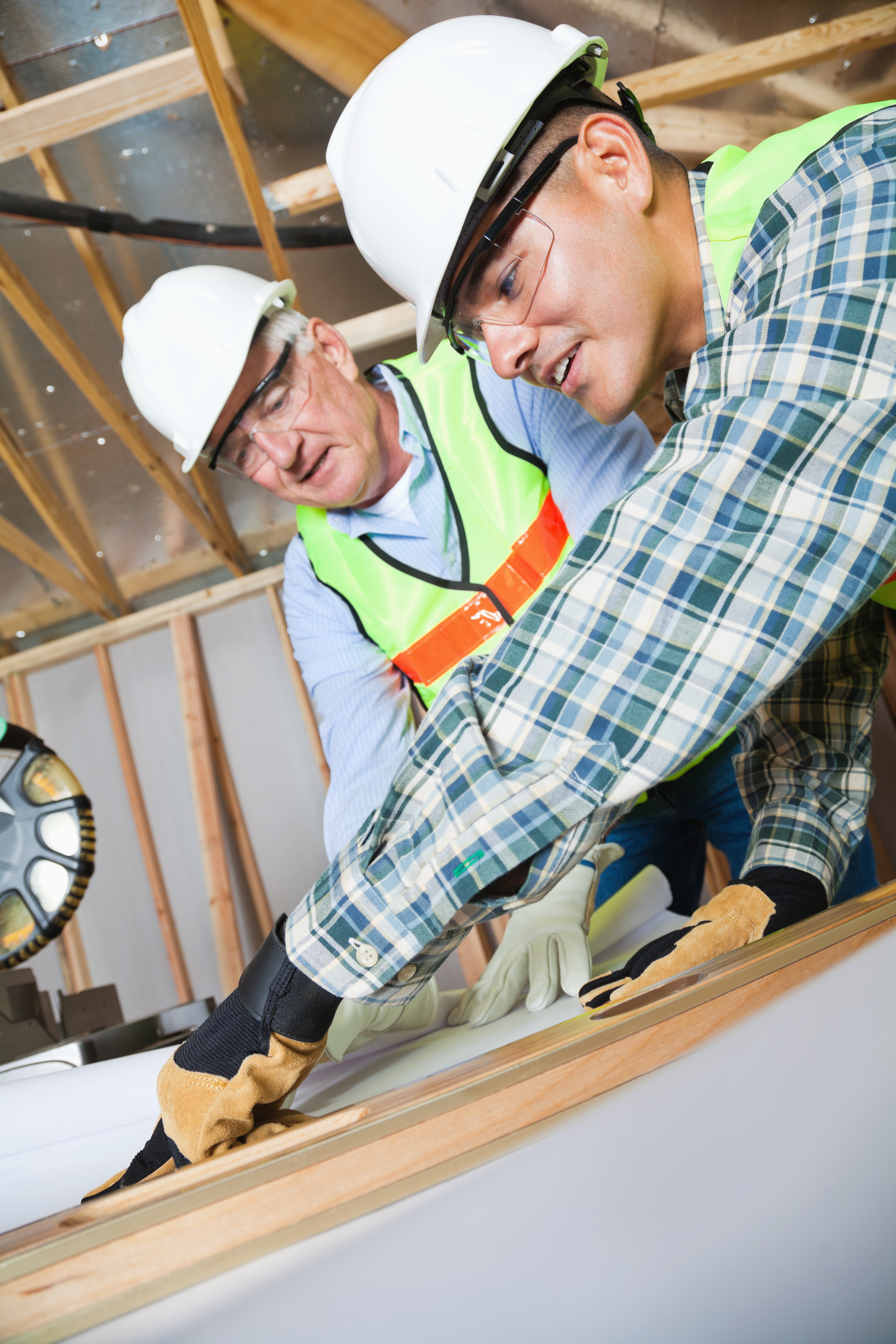 Two construction workers working together