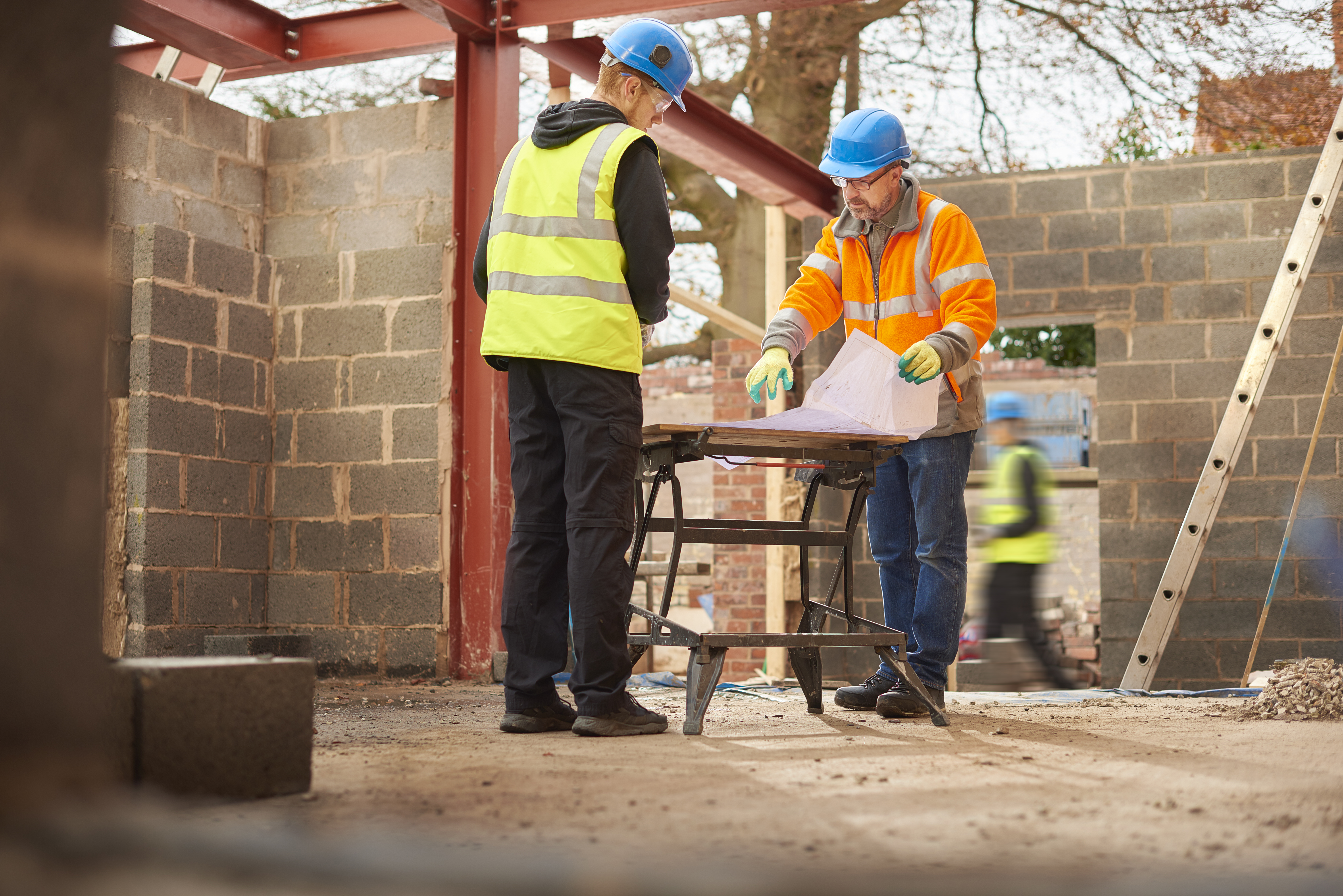 Two construction workers looking at plans