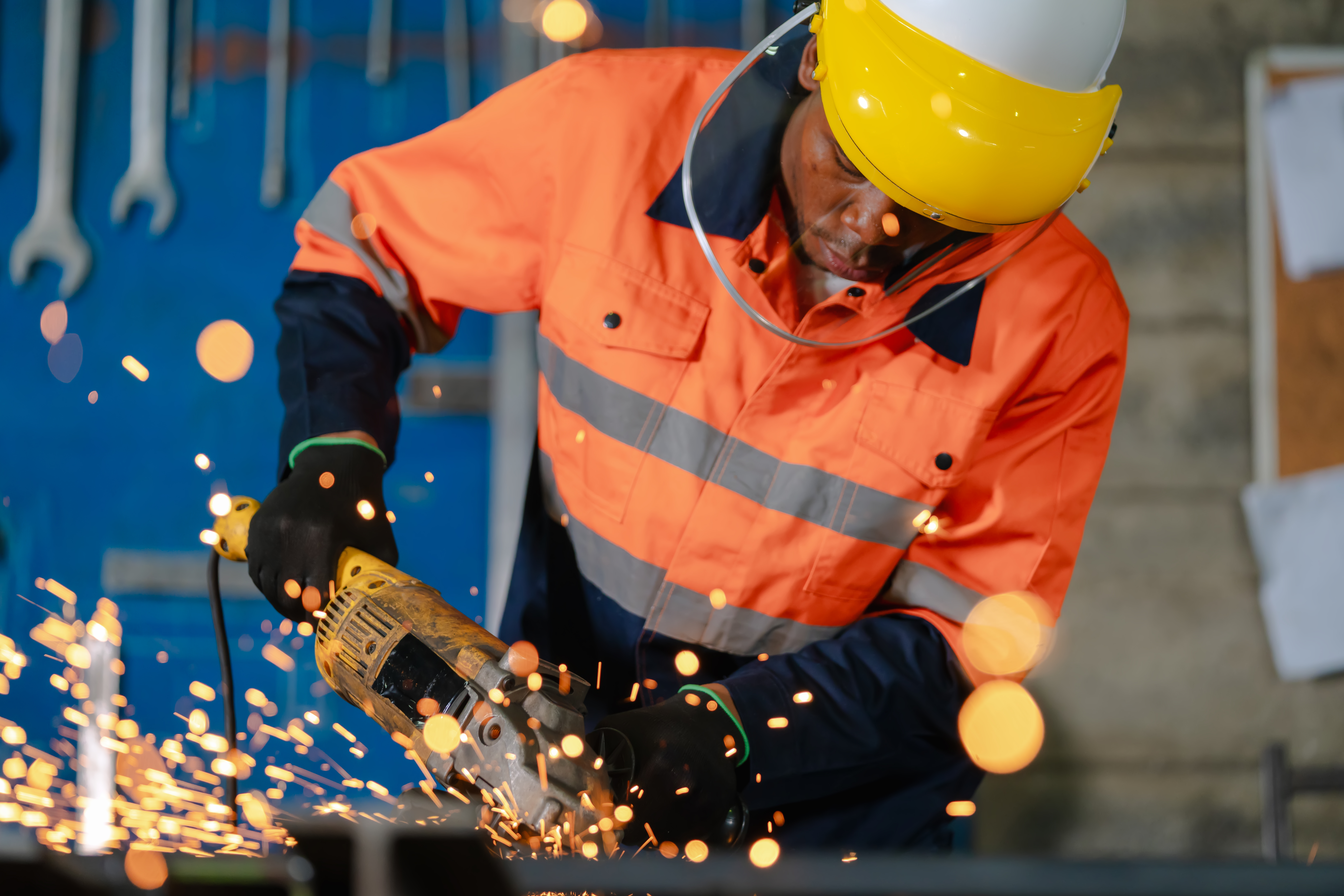 Construction worker using a power grinder