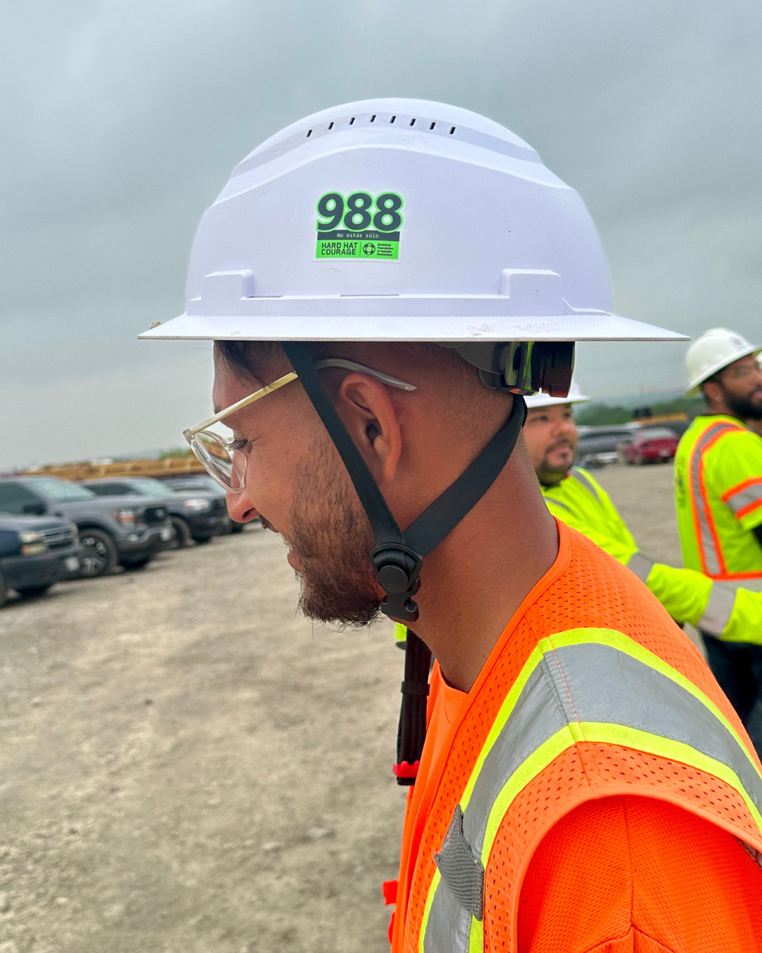 Man wearing hard hat with 988 sticker