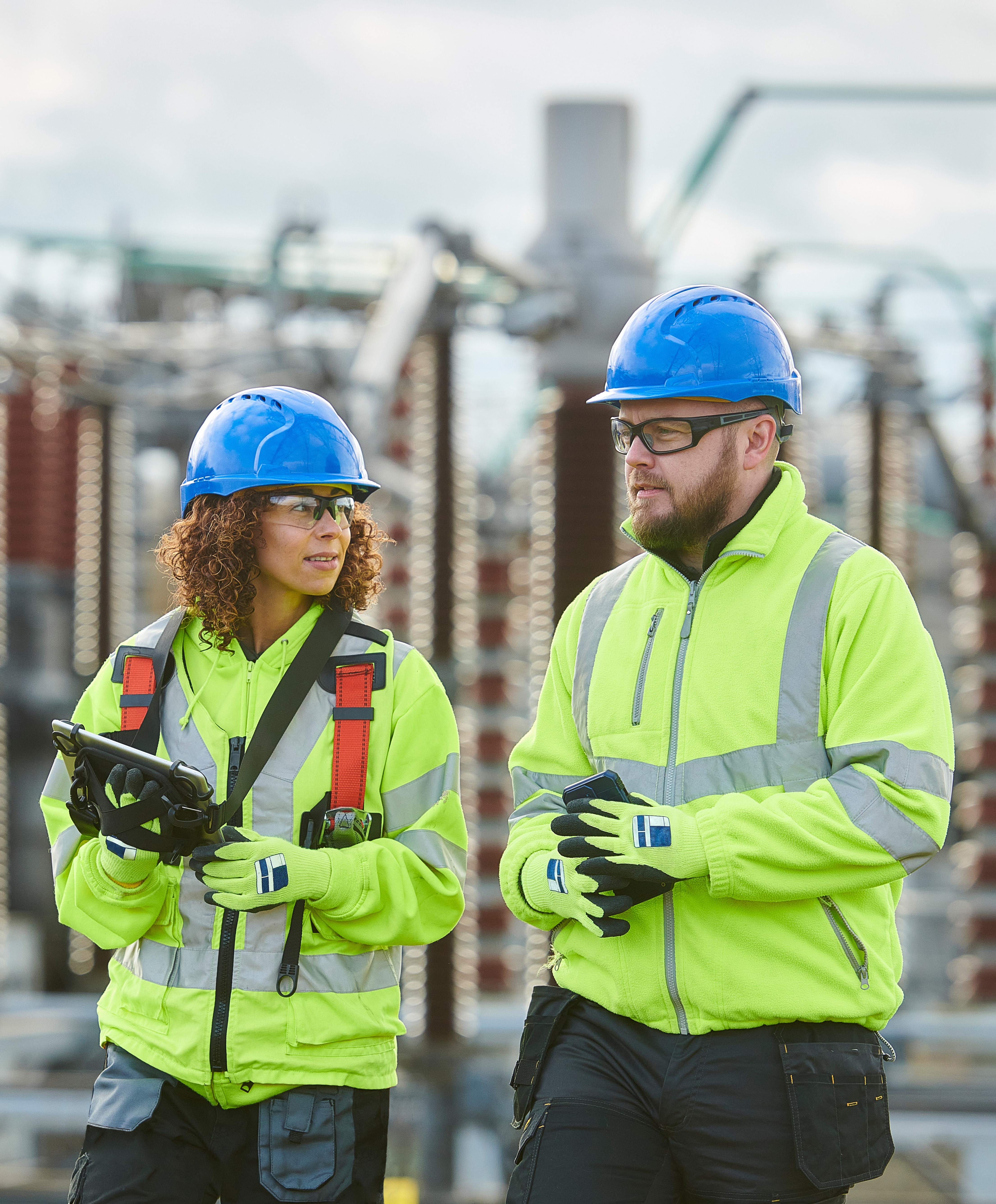Two construction workers talking on job site