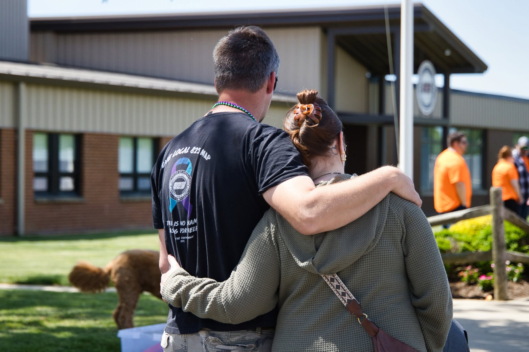 Two participants hugging each other