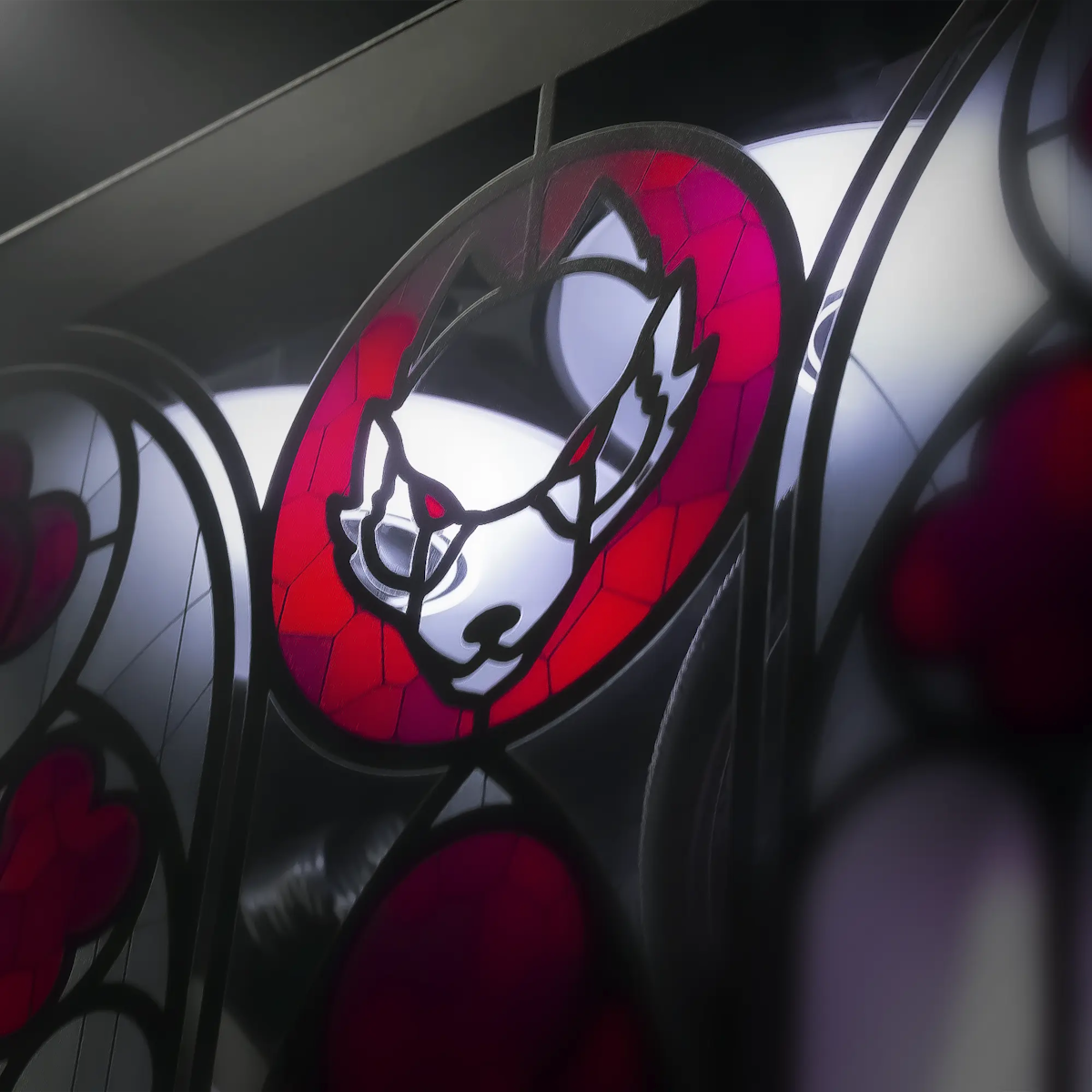 The wolf head on the Lord Aethelstan stained glass panel, crimson and black