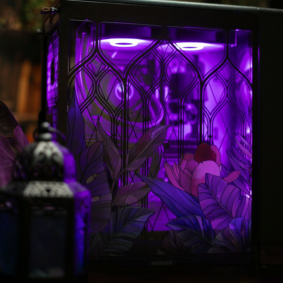Eden’s Veil in Grimthorn at night, the stained glass panel glowing purple from the lighting inside the case, a lantern beside it