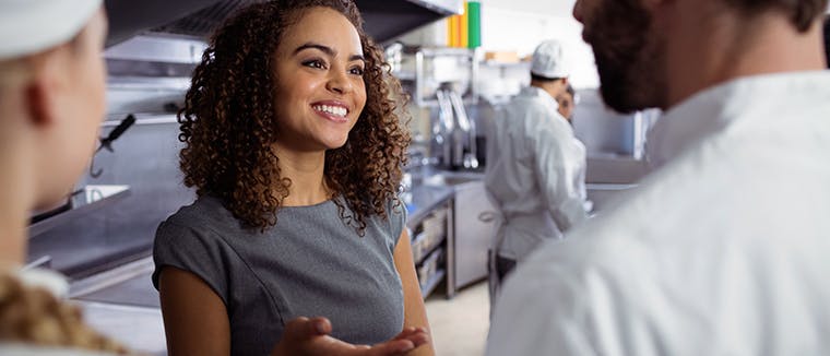 Restaurant, dark kitchen staff helping each other, Deliverect