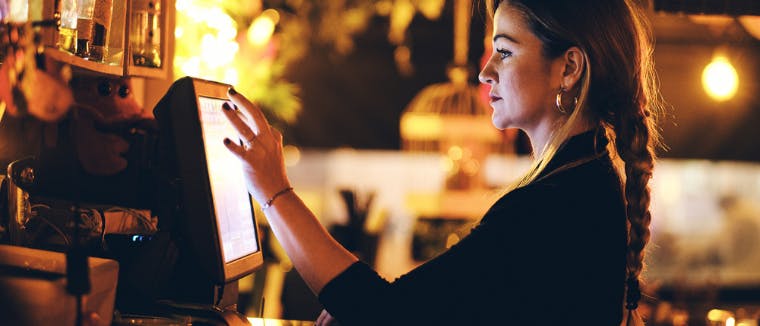 Woman entering delivery order in POS
