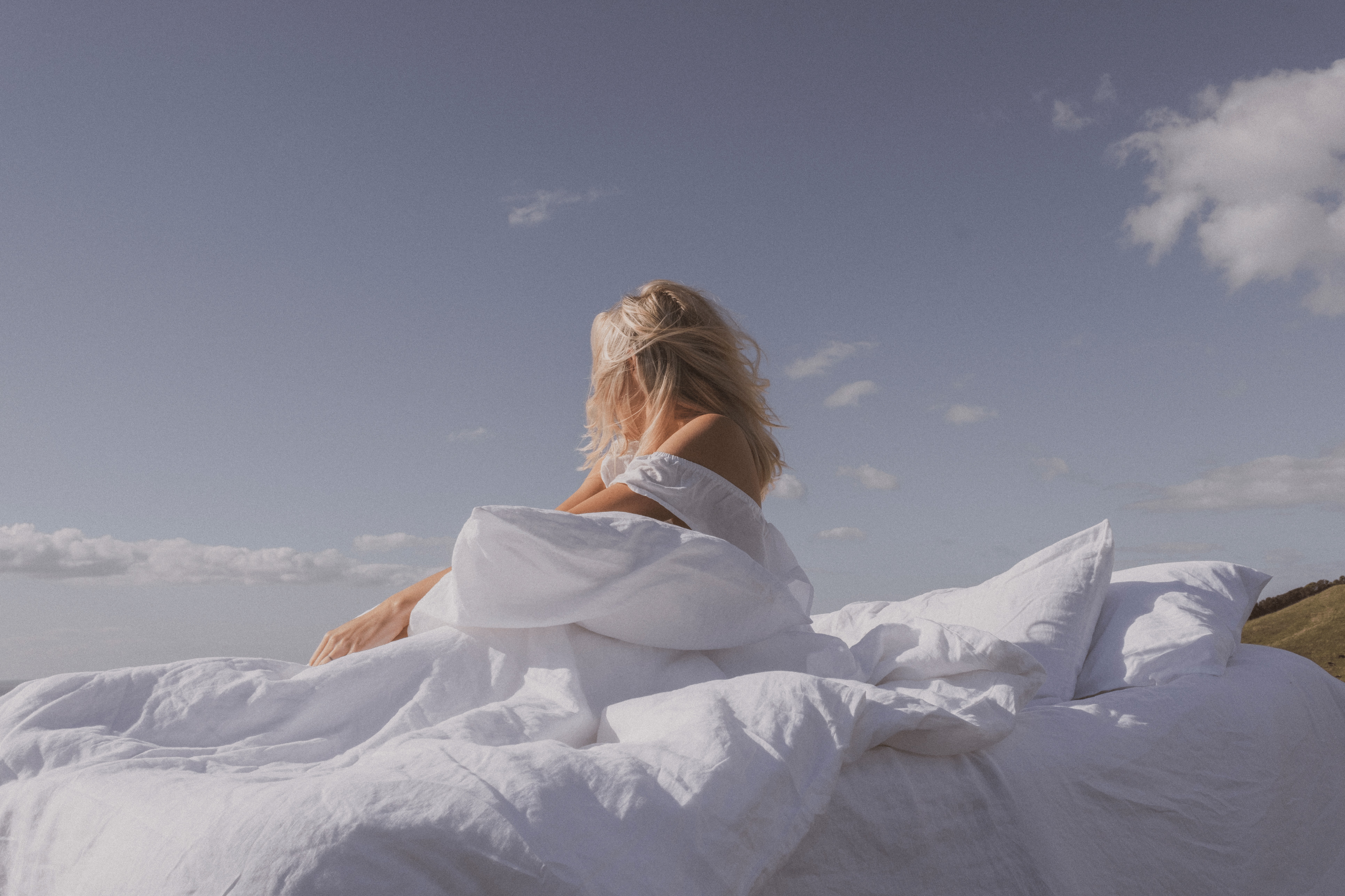 Woman in bed looking towards the sky