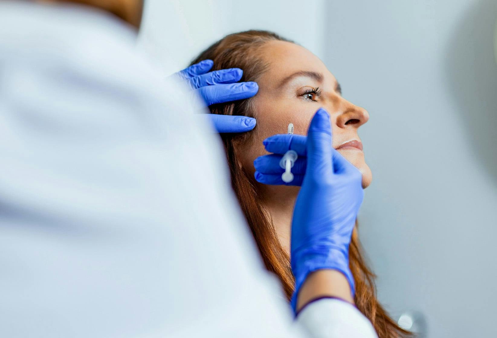 Woman receiving facial injections