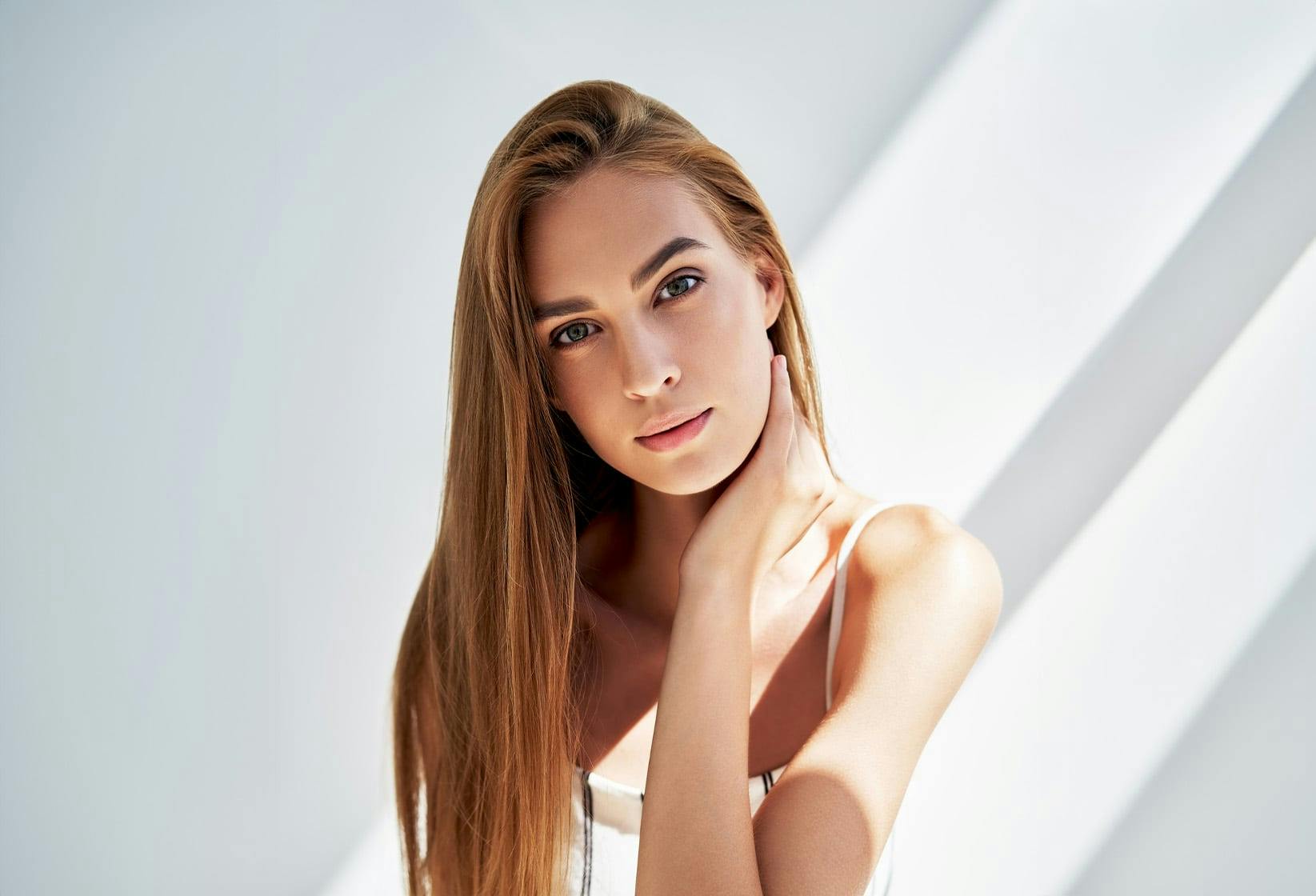 Woman with hand on her neck