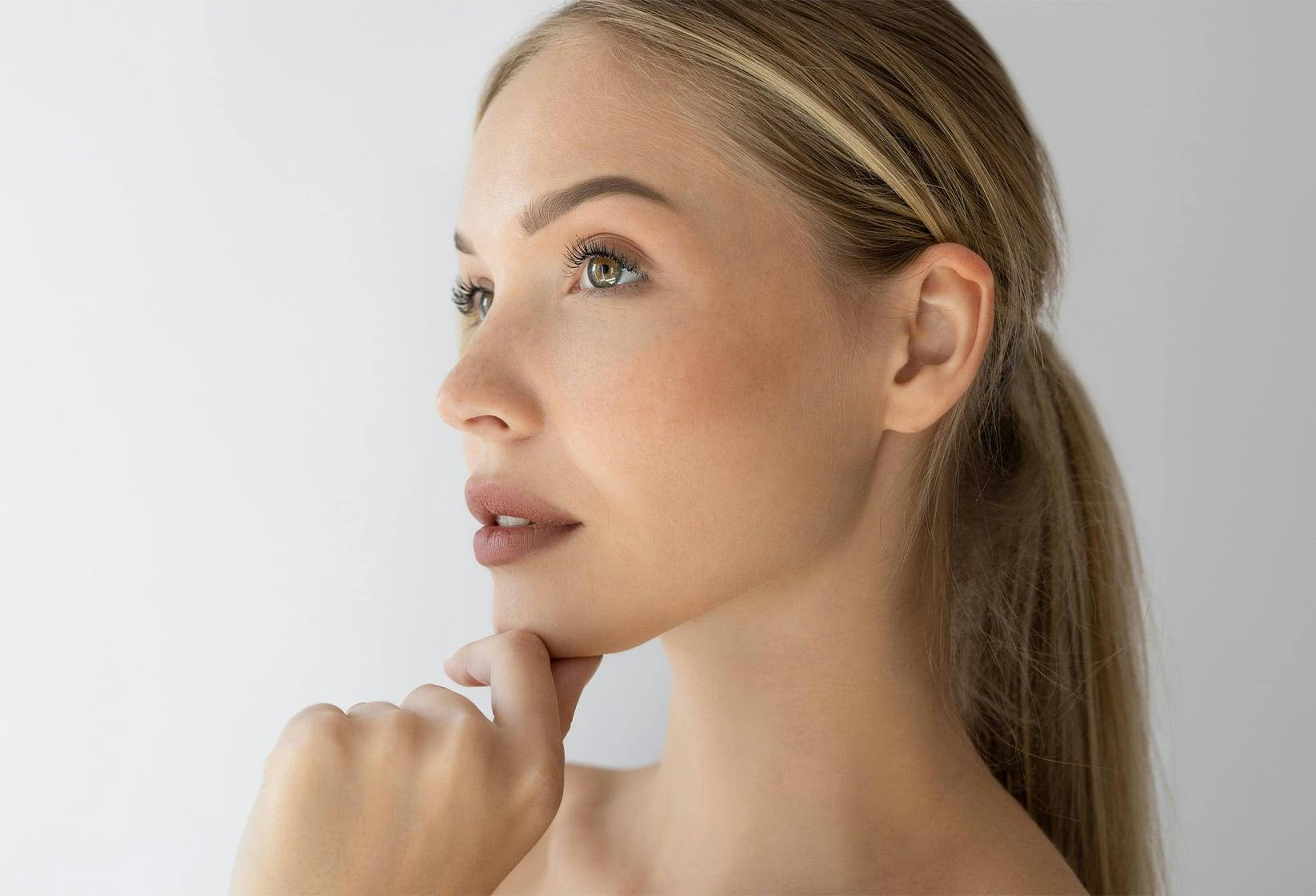 Woman with hand on her chin