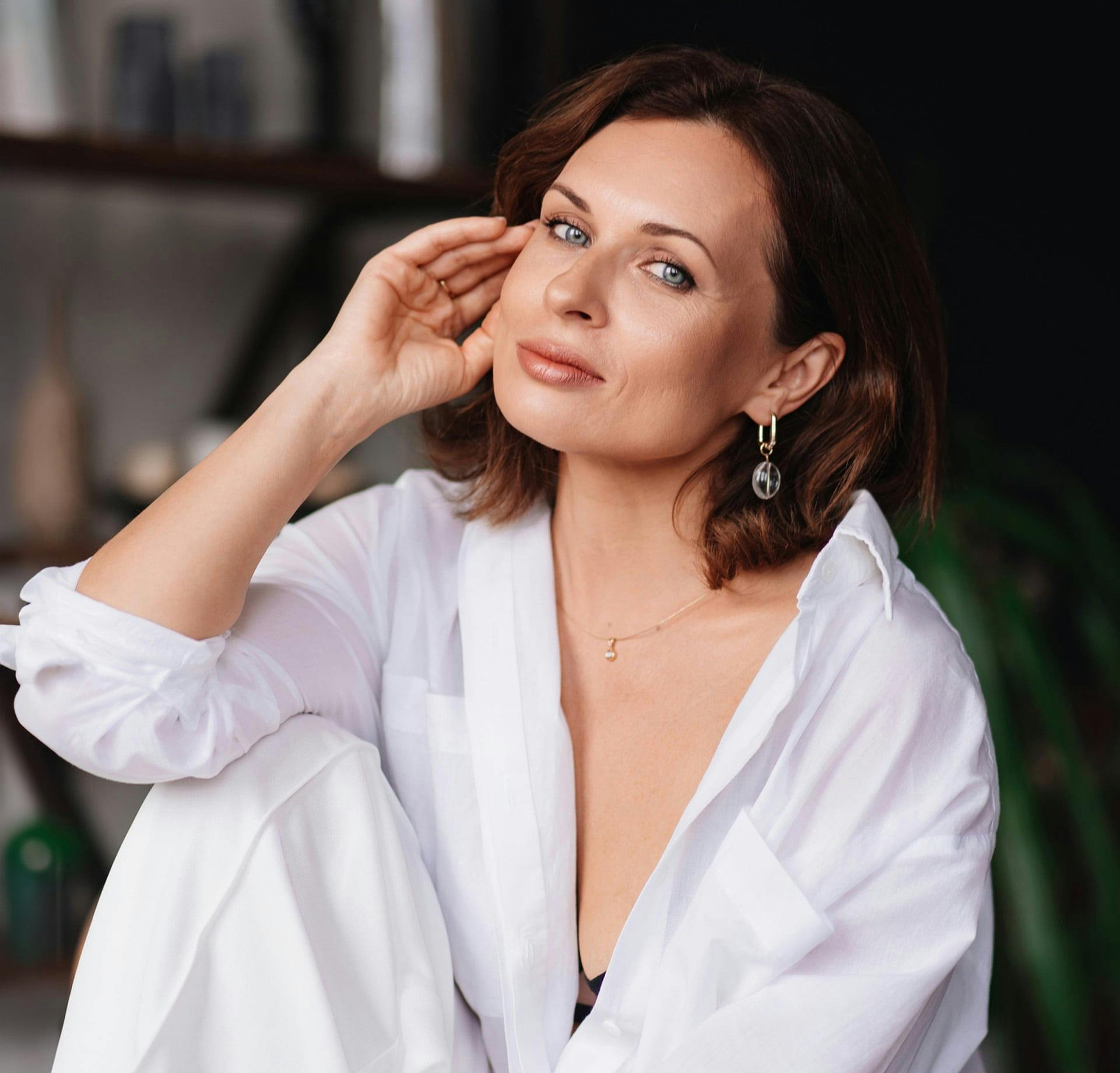 Woman sitting with hand near face