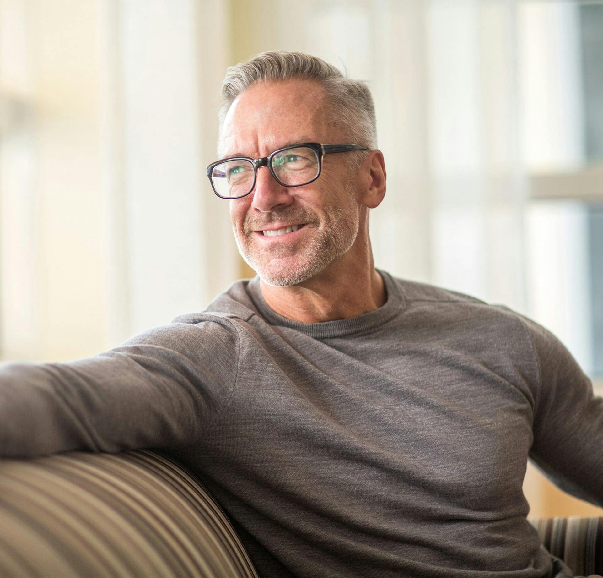 Man sitting on couch smiling