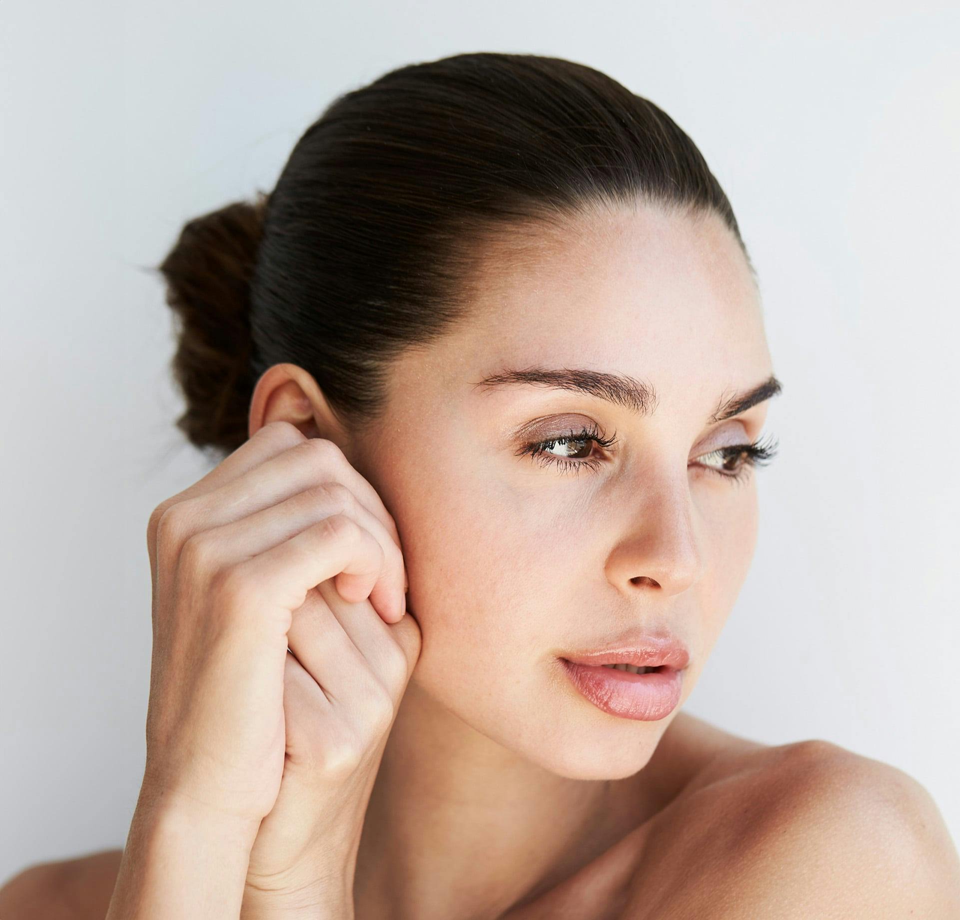 Woman with hands near ear