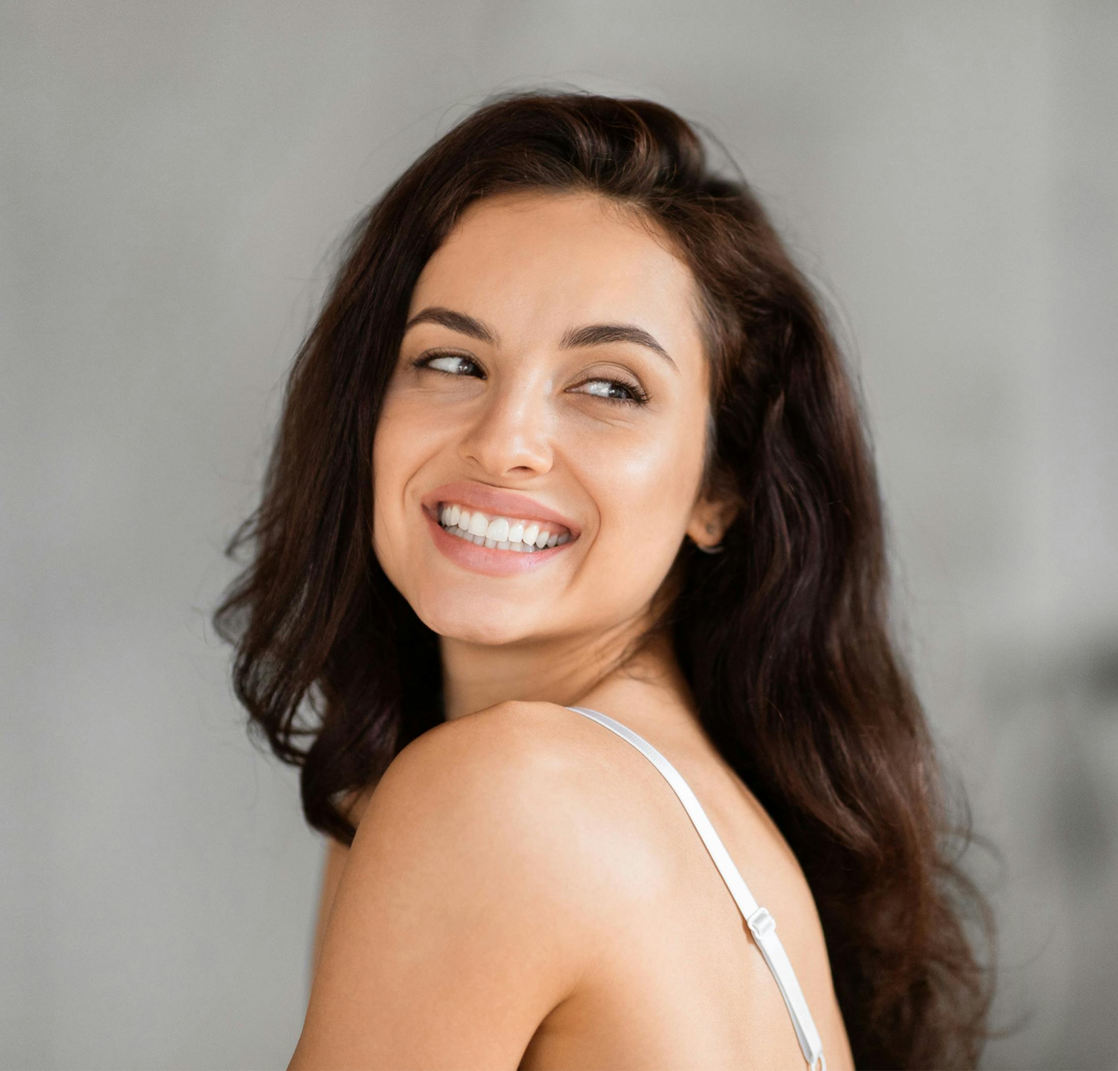 Woman smiling looking over her shoulder