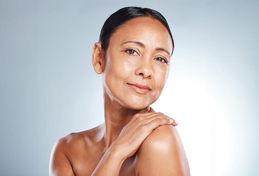 woman with her hand on her shoulder