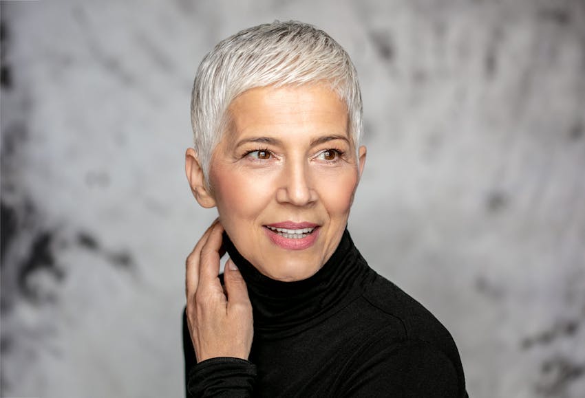 woman with grey hair wearing a black long sleeve shirt