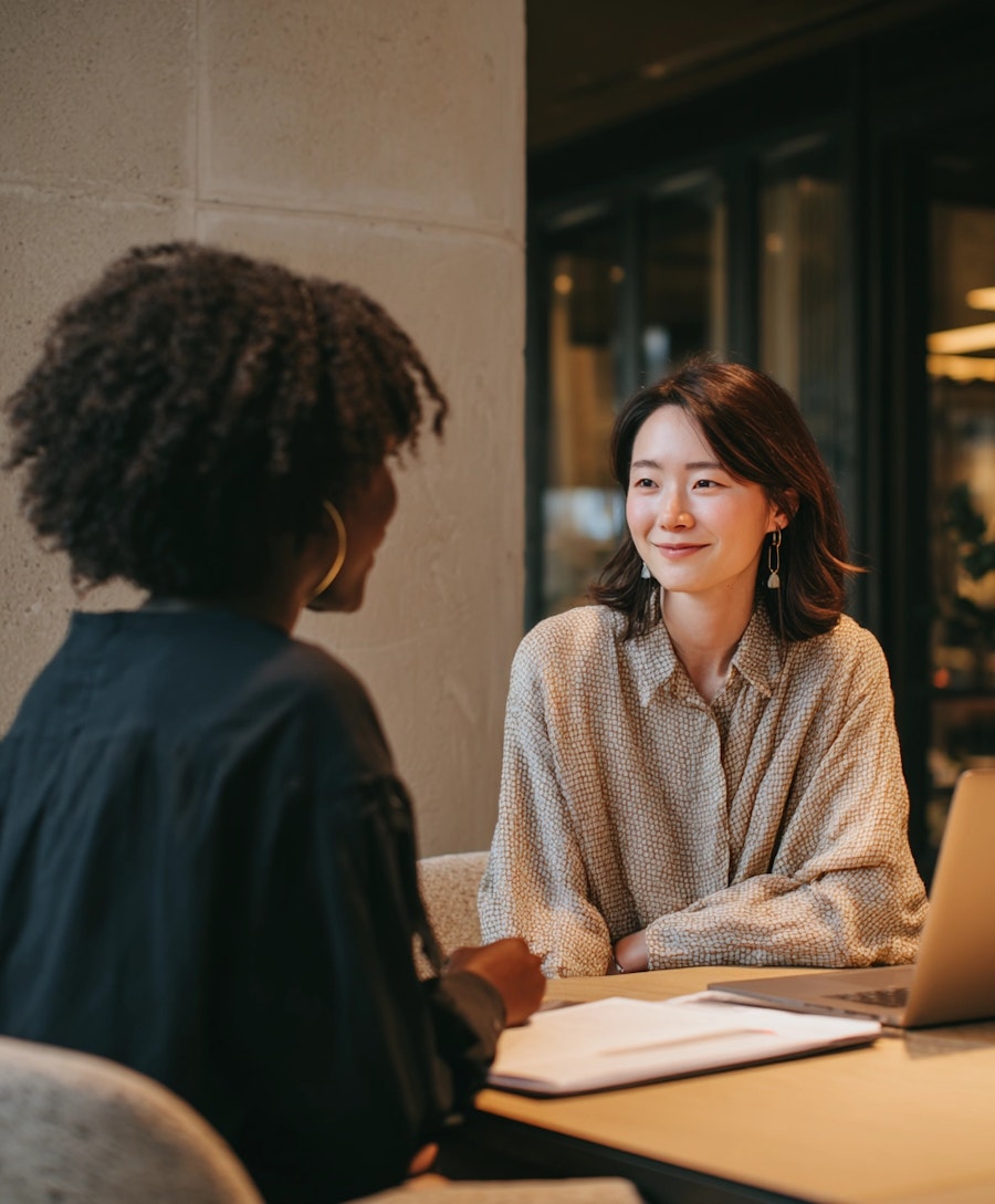 Two people engaged in an in-depth interview during a qualitative research session, representing global market research and participant-moderator interaction.
