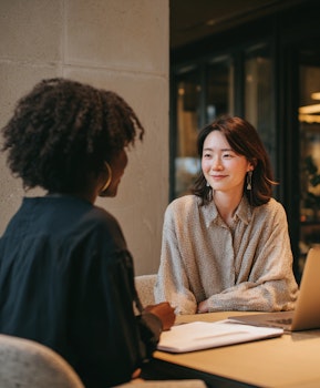 Two people engaged in an in-depth interview during a qualitative research session, representing global market research and participant-moderator interaction.
