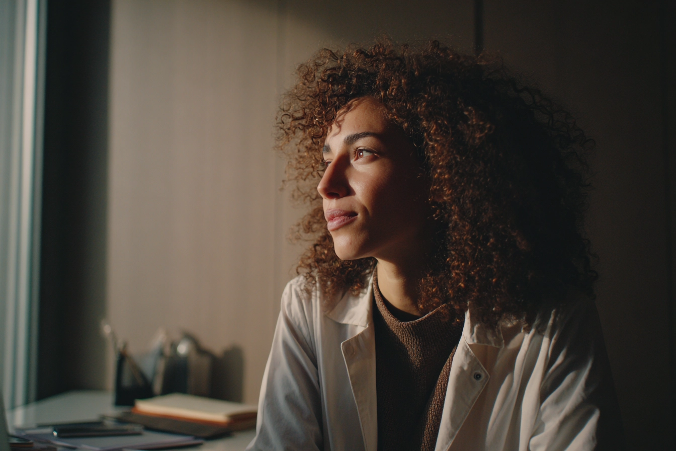Close-up of a woman reflecting during an ethnographic research observation session.