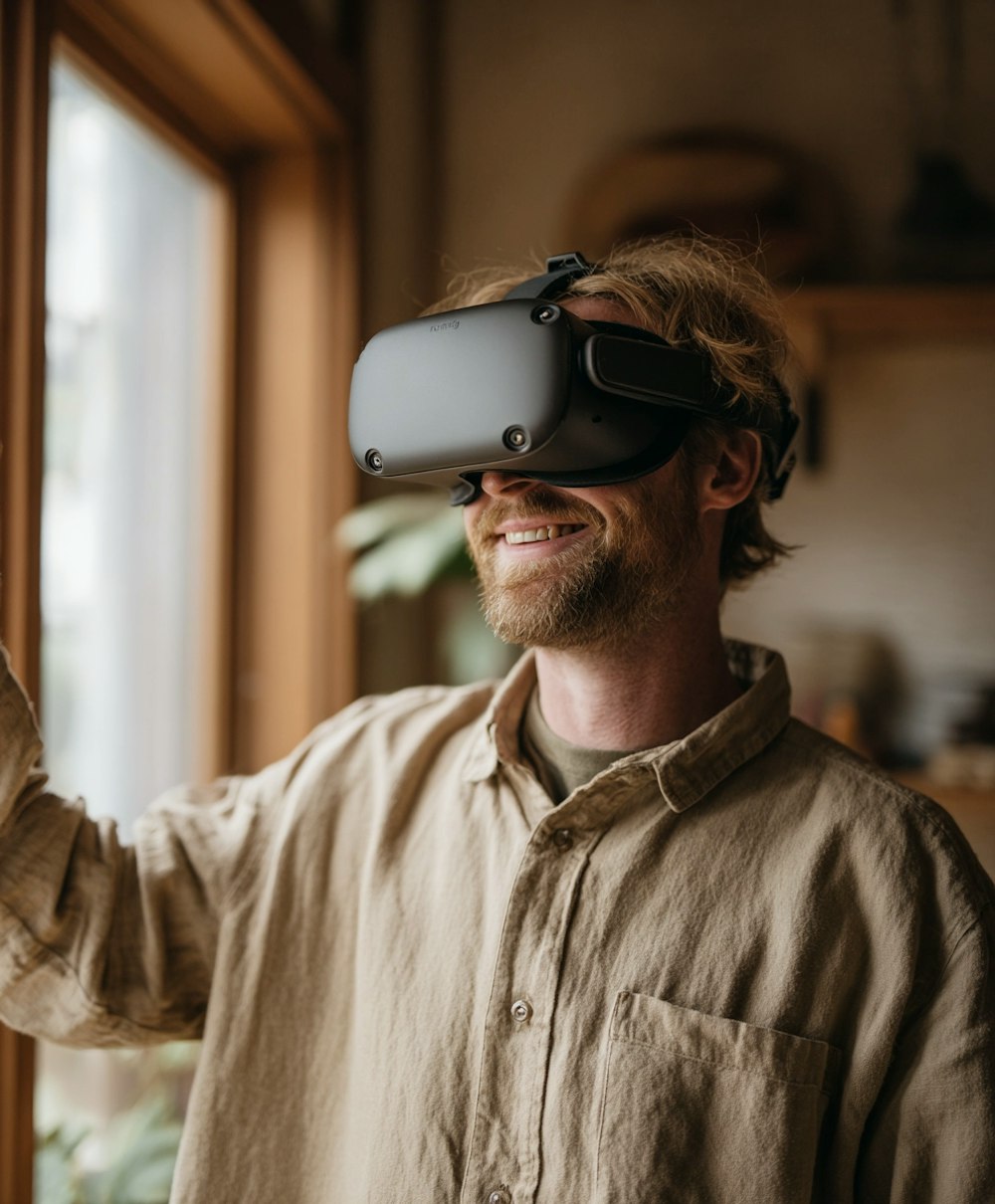 Man wearing a VR headset smiling while interacting in a warm, naturally lit living room