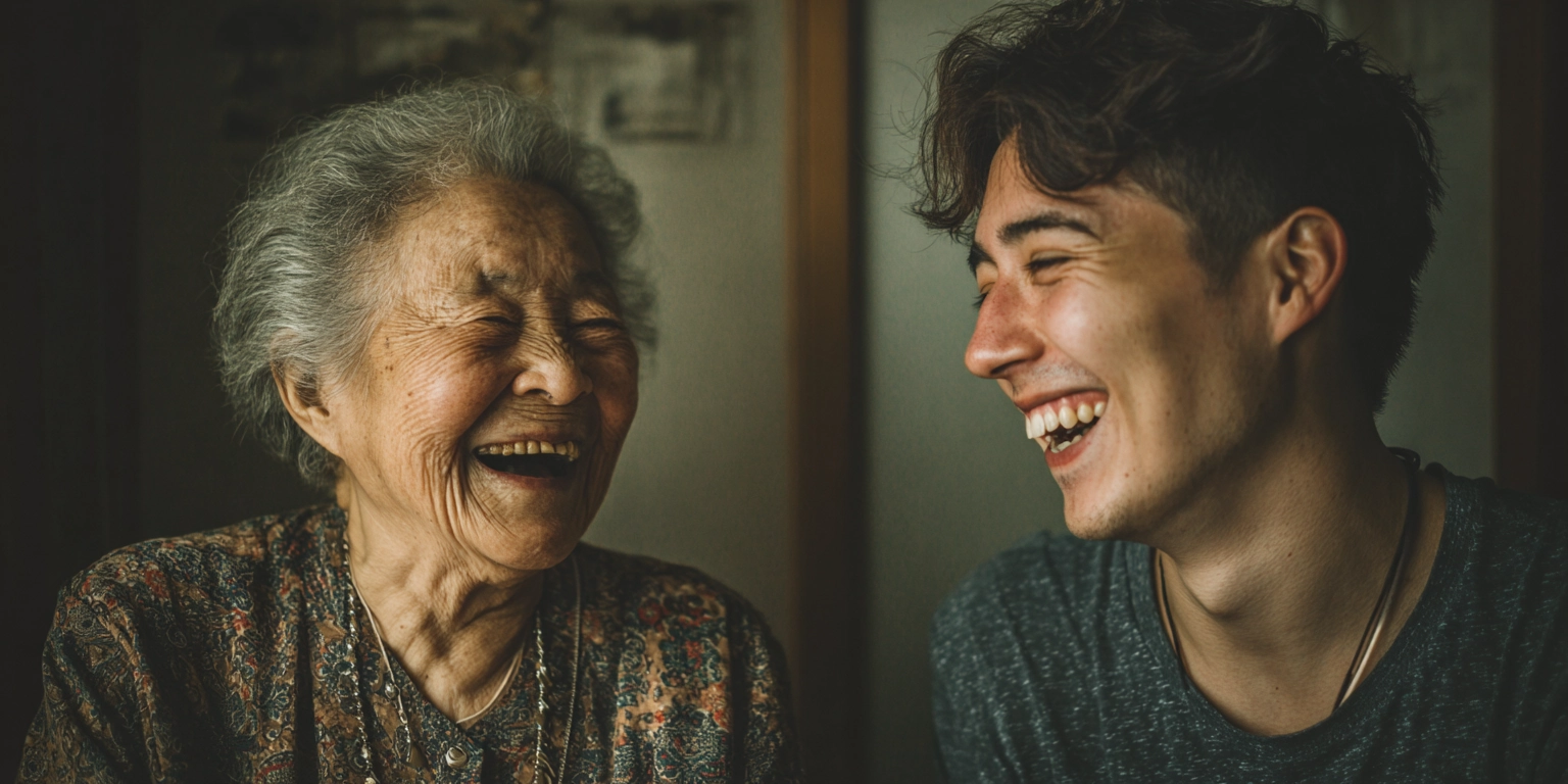 Elderly woman and young man sharing a genuine laugh during qualitative research interview